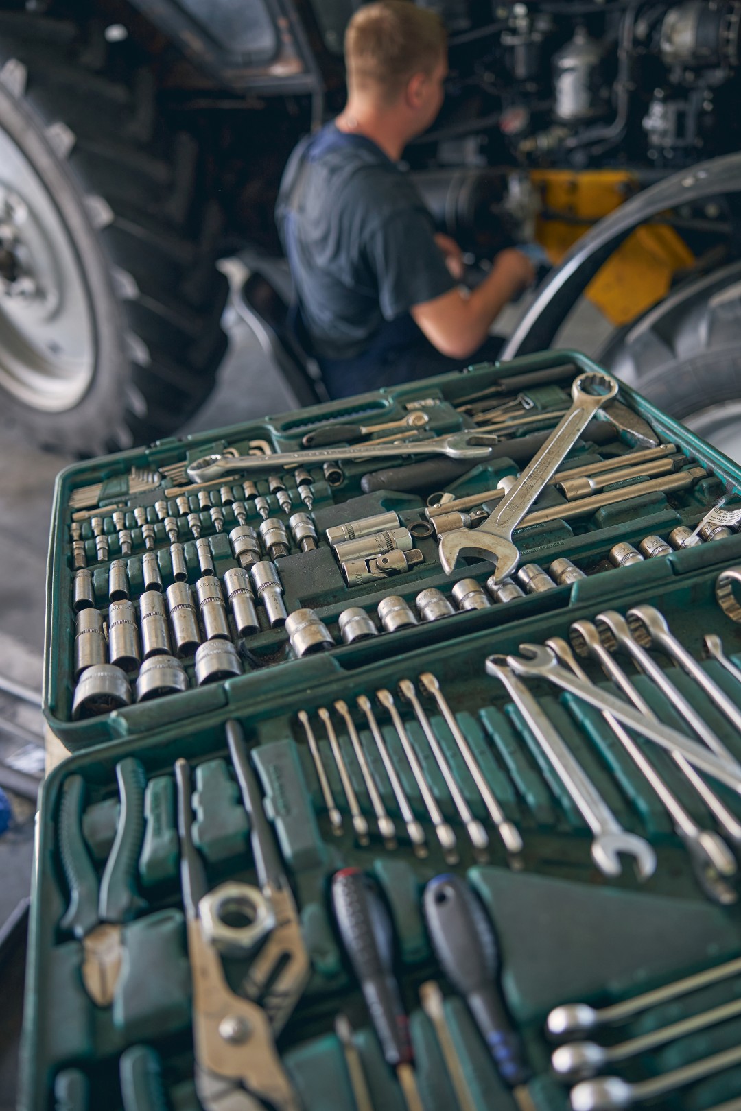 picture focused on a mechanics tools laid out while he works