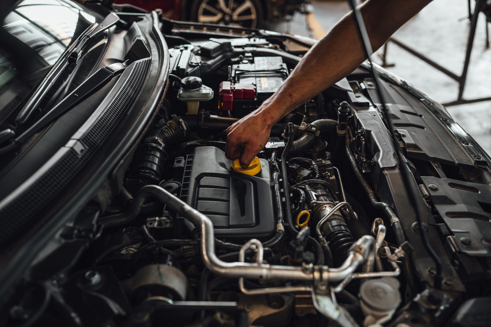 A closeup shot of auto mechanic hands doing a car technical inspection in service